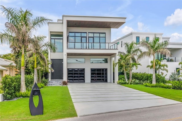 1194 N Peninsula, New Smyrna Beach, FL 32169 - contemporary home with stucco siding, a balcony, concrete driveway, and an attached garage