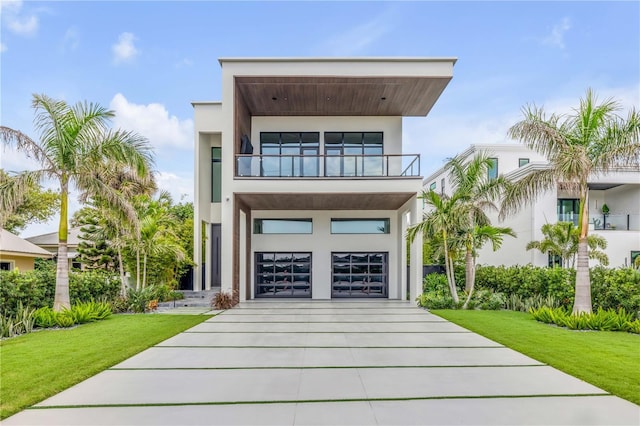 1194 N Peninsula, New Smyrna Beach, FL 32169 - modern home with a balcony, a front yard, and stucco siding