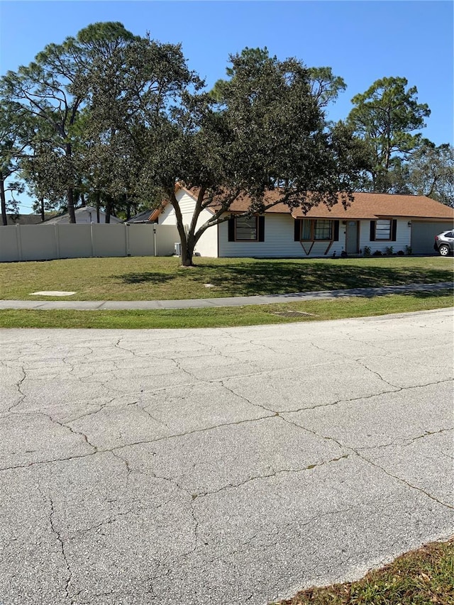 exterior space with a front yard and fence