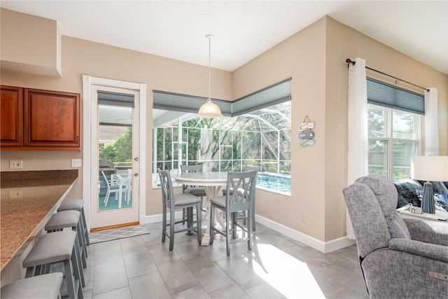 dining area with plenty of natural light, baseboards, and a sunroom