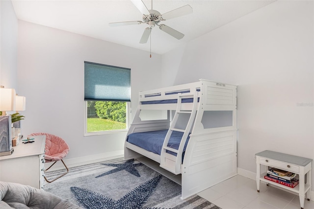 bedroom with tile patterned floors, ceiling fan, and baseboards