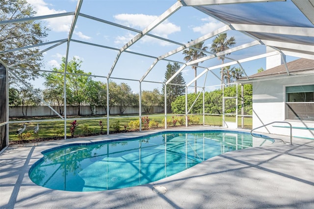 view of swimming pool featuring a fenced in pool, fence, a lanai, a lawn, and a patio area