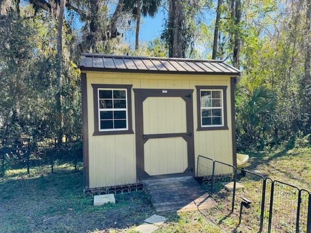 view of shed with fence