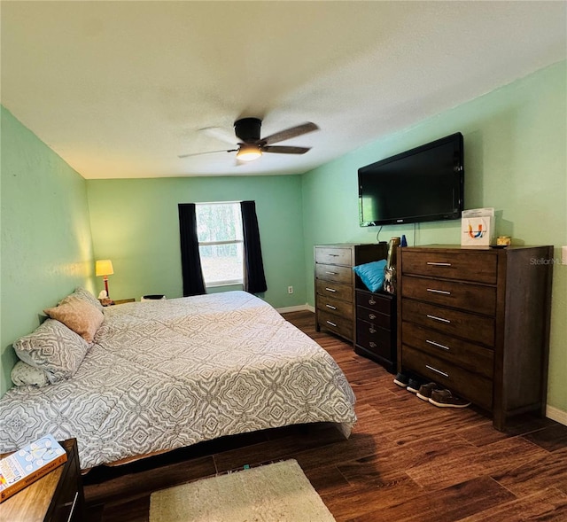 bedroom featuring baseboards, dark wood-style flooring, and ceiling fan