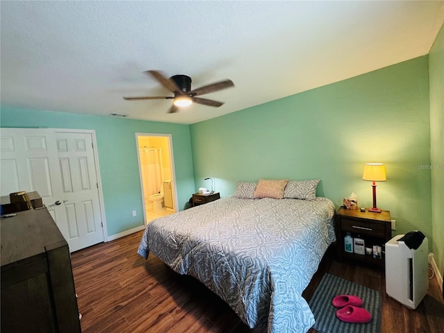 bedroom with wood finished floors, visible vents, baseboards, ensuite bath, and ceiling fan