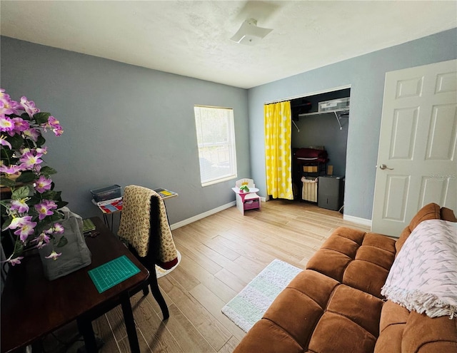 interior space with baseboards and wood finished floors