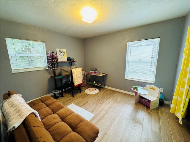 rec room featuring baseboards and wood finished floors