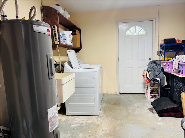 laundry room with laundry area, washing machine and dryer, and water heater