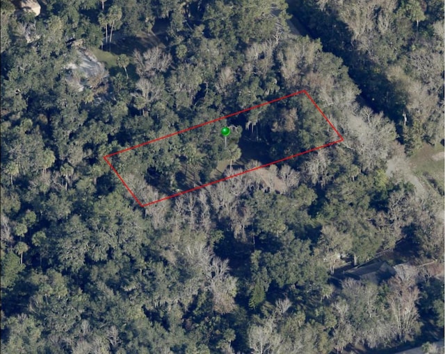 drone / aerial view featuring a forest view