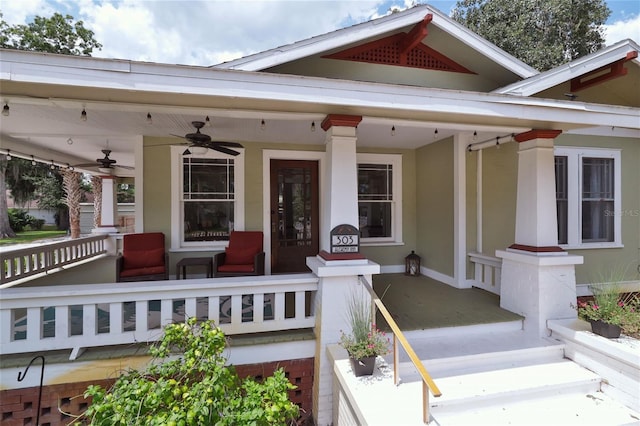 view of exterior entry featuring stucco siding, a porch, and ceiling fan