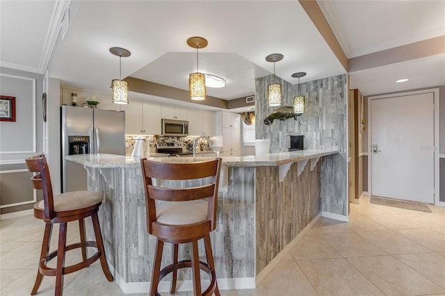 533 Marina Point Dr Unit 533, Daytona Beach, FL 32114 - kitchen with light stone counters, light tile patterned floors, white cabinets, decorative light fixtures, and stainless steel appliances