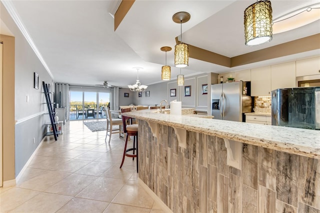 533 Marina Point Dr Unit 533, Daytona Beach, FL 32114 - kitchen featuring stainless steel fridge with ice dispenser, ornamental molding, light tile patterned floors, backsplash, and light stone countertops
