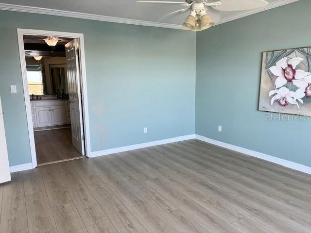 533 Marina Point Dr Unit 533, Daytona Beach, FL 32114 - unfurnished bedroom with baseboards, ornamental molding, and wood finished floors