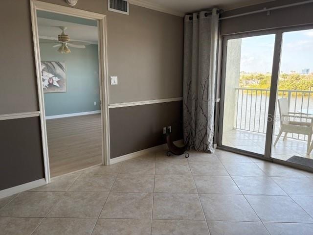 533 Marina Point Dr Unit 533, Daytona Beach, FL 32114 - spare room with visible vents, baseboards, a ceiling fan, crown molding, and light tile patterned flooring