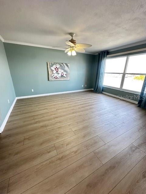 533 Marina Point Dr Unit 533, Daytona Beach, FL 32114 - unfurnished room featuring ornamental molding, baseboards, a ceiling fan, and wood finished floors