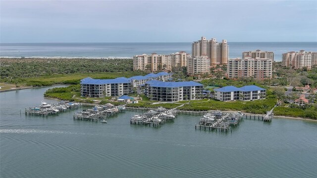 birds eye view of property with a water view and a city view