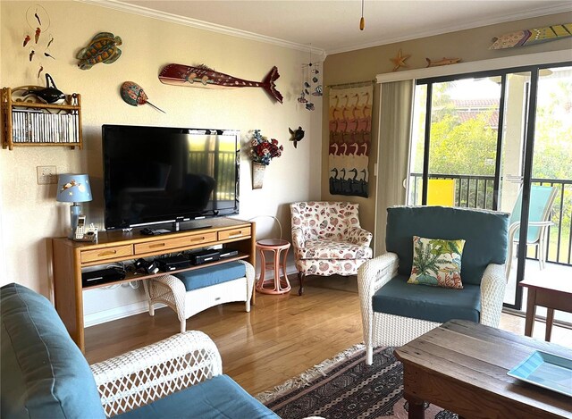 living area featuring ornamental molding and wood finished floors
