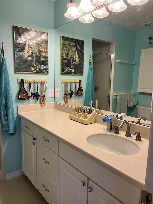 full bathroom featuring vanity, toilet, tile patterned floors, a stall shower, and visible vents