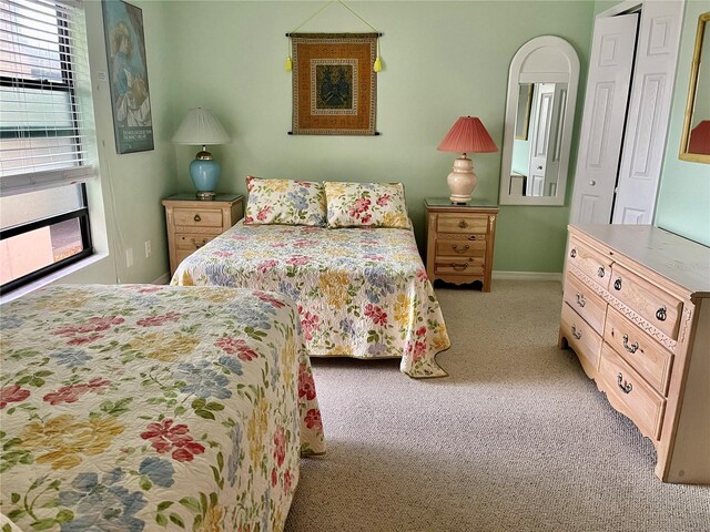 bedroom with baseboards and carpet flooring