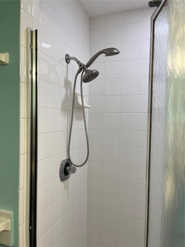 room details featuring a stall shower and a textured wall