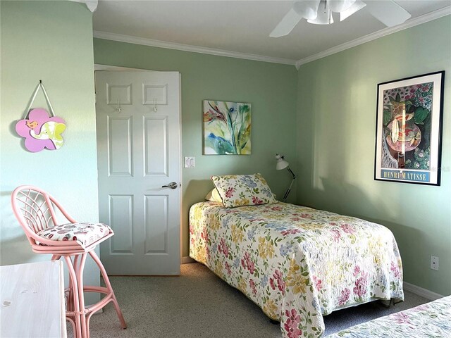 carpeted bedroom with baseboards, ornamental molding, and a ceiling fan