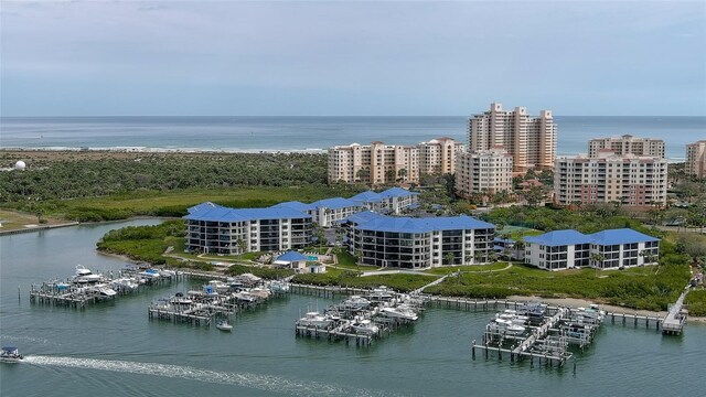 drone / aerial view featuring a water view and a view of city