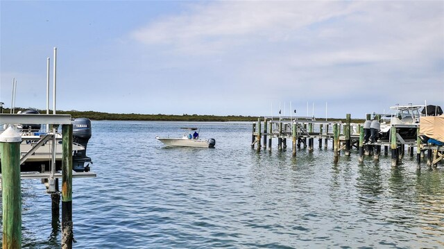 dock area featuring boat lift and a water view