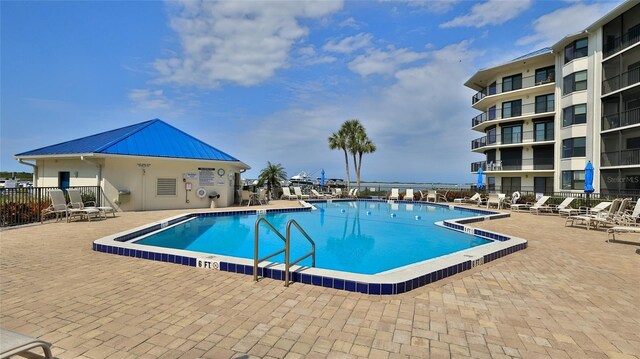 pool featuring a patio and fence