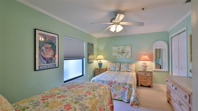 2700 N Peninsula Ave Unit 113, New Smyrna Beach, FL 32169 - carpeted bedroom featuring ornamental molding, ceiling fan, and a closet