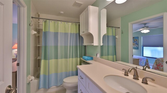 2700 N Peninsula Ave Unit 113, New Smyrna Beach, FL 32169 - ensuite bathroom with vanity, toilet, a ceiling fan, and shower / bath combination with curtain