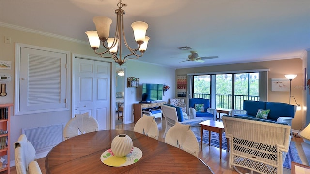 2700 N Peninsula Ave Unit 113, New Smyrna Beach, FL 32169 - dining space with a chandelier, ceiling fan, ornamental molding, and wood finished floors