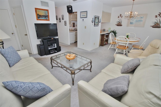 living area with visible vents, light colored carpet, and an inviting chandelier