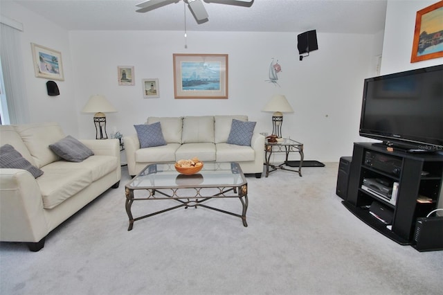 living area with a ceiling fan and carpet flooring