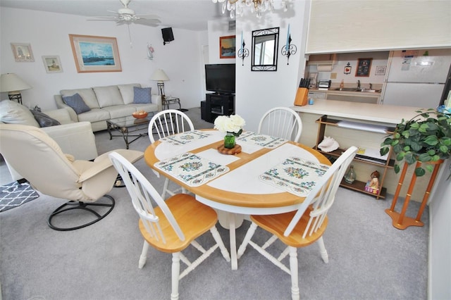 dining space featuring a ceiling fan and carpet