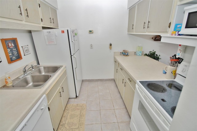 kitchen featuring white appliances, light tile patterned floors, baseboards, a sink, and light countertops