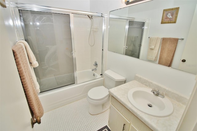 full bath with tile patterned flooring, toilet, vanity, and shower / bath combination with glass door