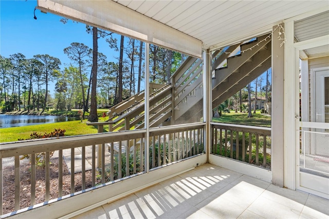 unfurnished sunroom featuring a water view