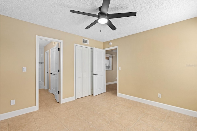 unfurnished bedroom featuring baseboards, visible vents, a closet, and a textured ceiling