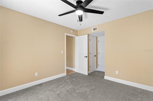 unfurnished bedroom with baseboards, visible vents, carpet floors, ceiling fan, and a textured ceiling