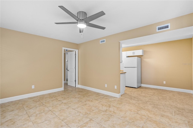 empty room with visible vents, baseboards, ceiling fan, and light tile patterned flooring