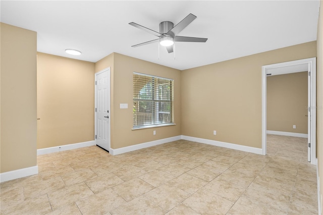 unfurnished room with light tile patterned flooring, ceiling fan, and baseboards