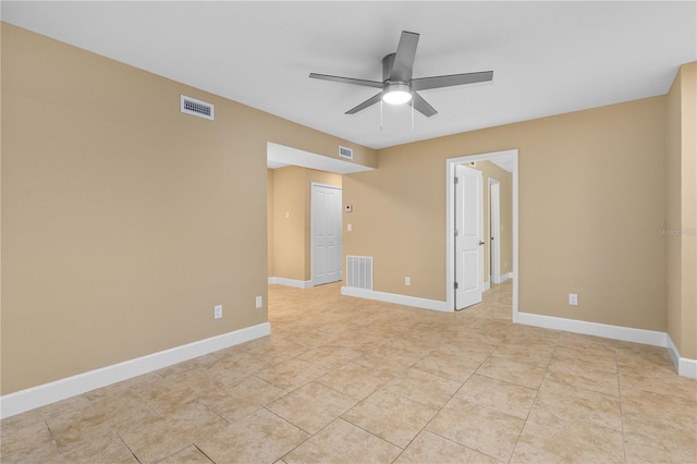 spare room with a ceiling fan, baseboards, and visible vents