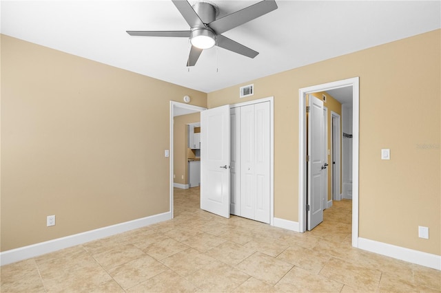 unfurnished bedroom with visible vents, a closet, light tile patterned floors, baseboards, and ceiling fan