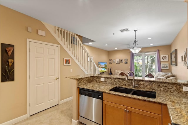 kitchen featuring stainless steel dishwasher, light stone countertops, open floor plan, and a sink