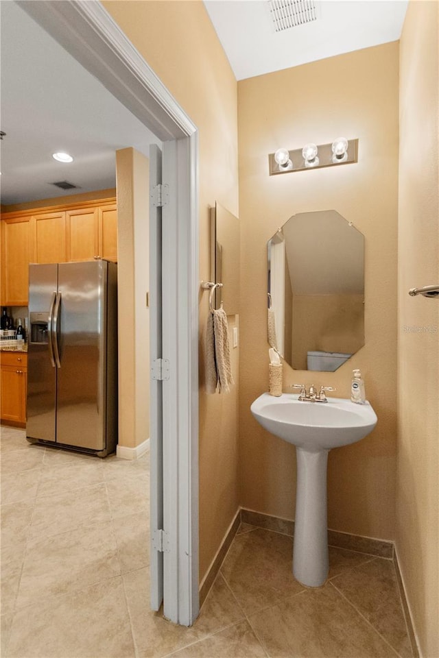 bathroom featuring tile patterned floors, baseboards, and visible vents