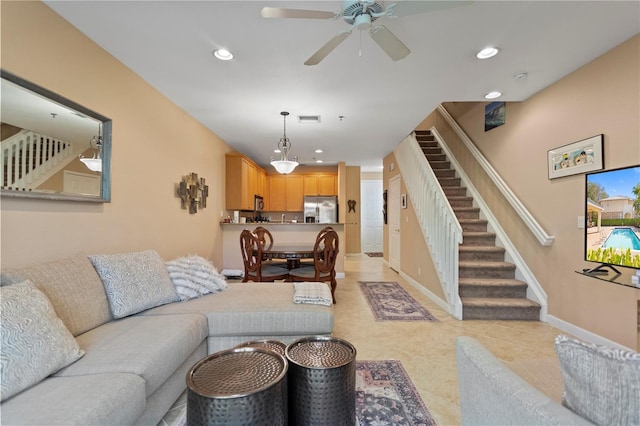 living area featuring stairs, visible vents, recessed lighting, and baseboards