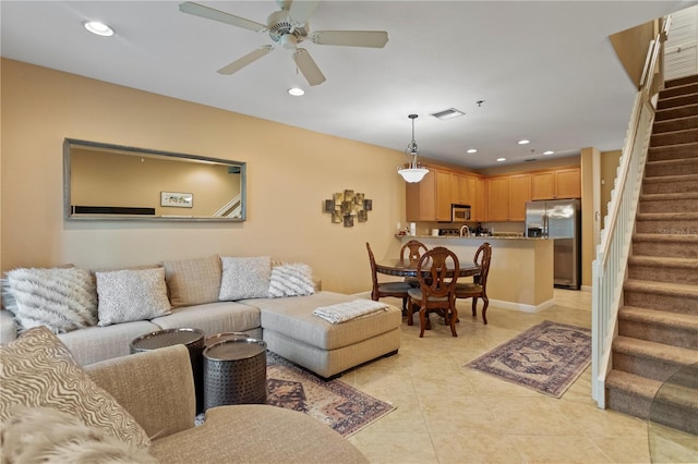 living area with visible vents, a ceiling fan, recessed lighting, stairway, and light tile patterned floors