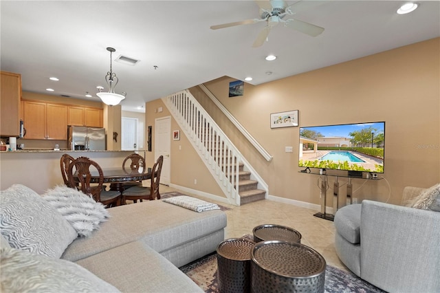 living area featuring recessed lighting, visible vents, baseboards, and stairs