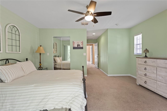 carpeted bedroom featuring visible vents, ceiling fan, and baseboards