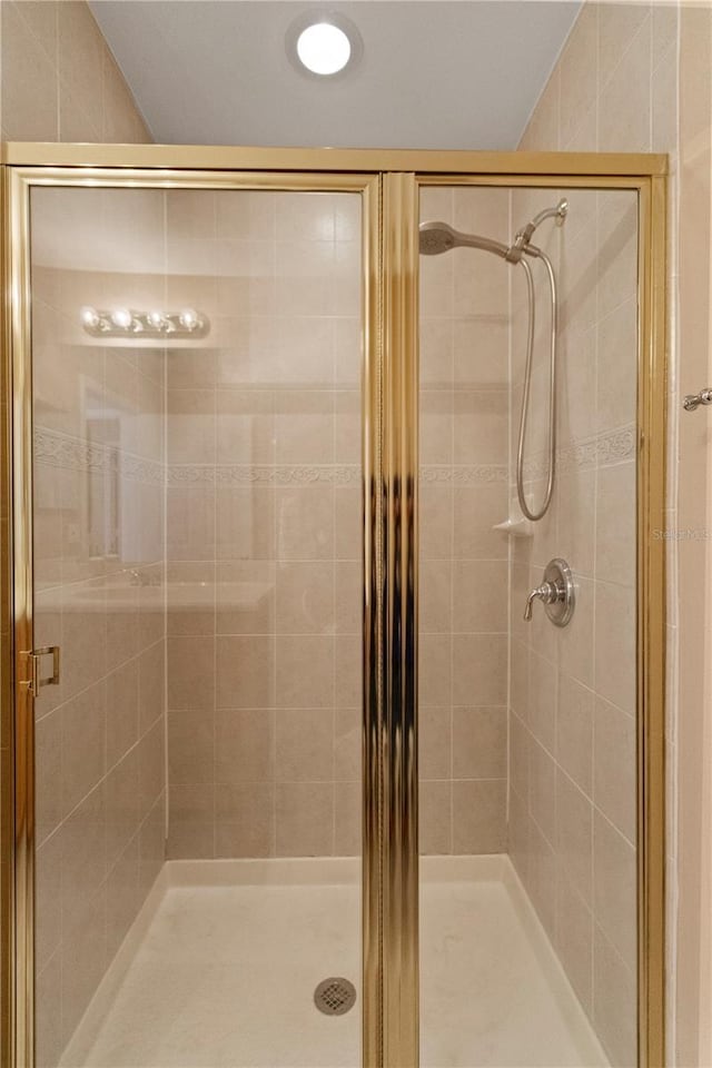 full bath featuring a shower stall